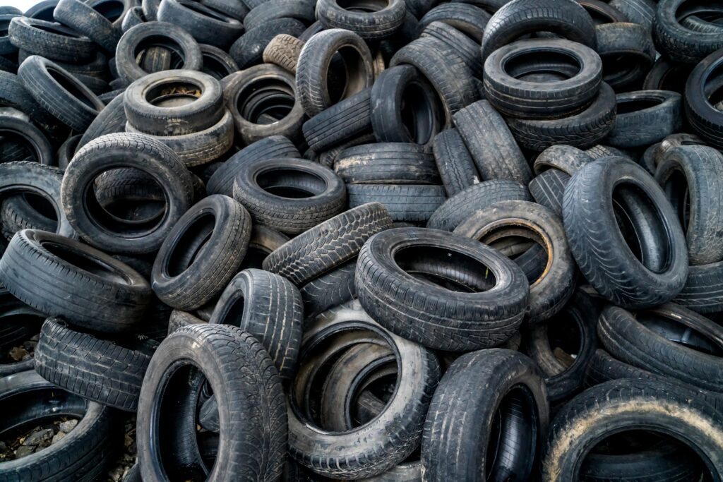 A close up of hundreds of waste tyres.
