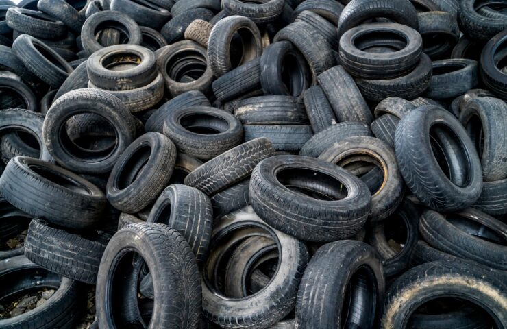 A close up of hundreds of waste tyres.