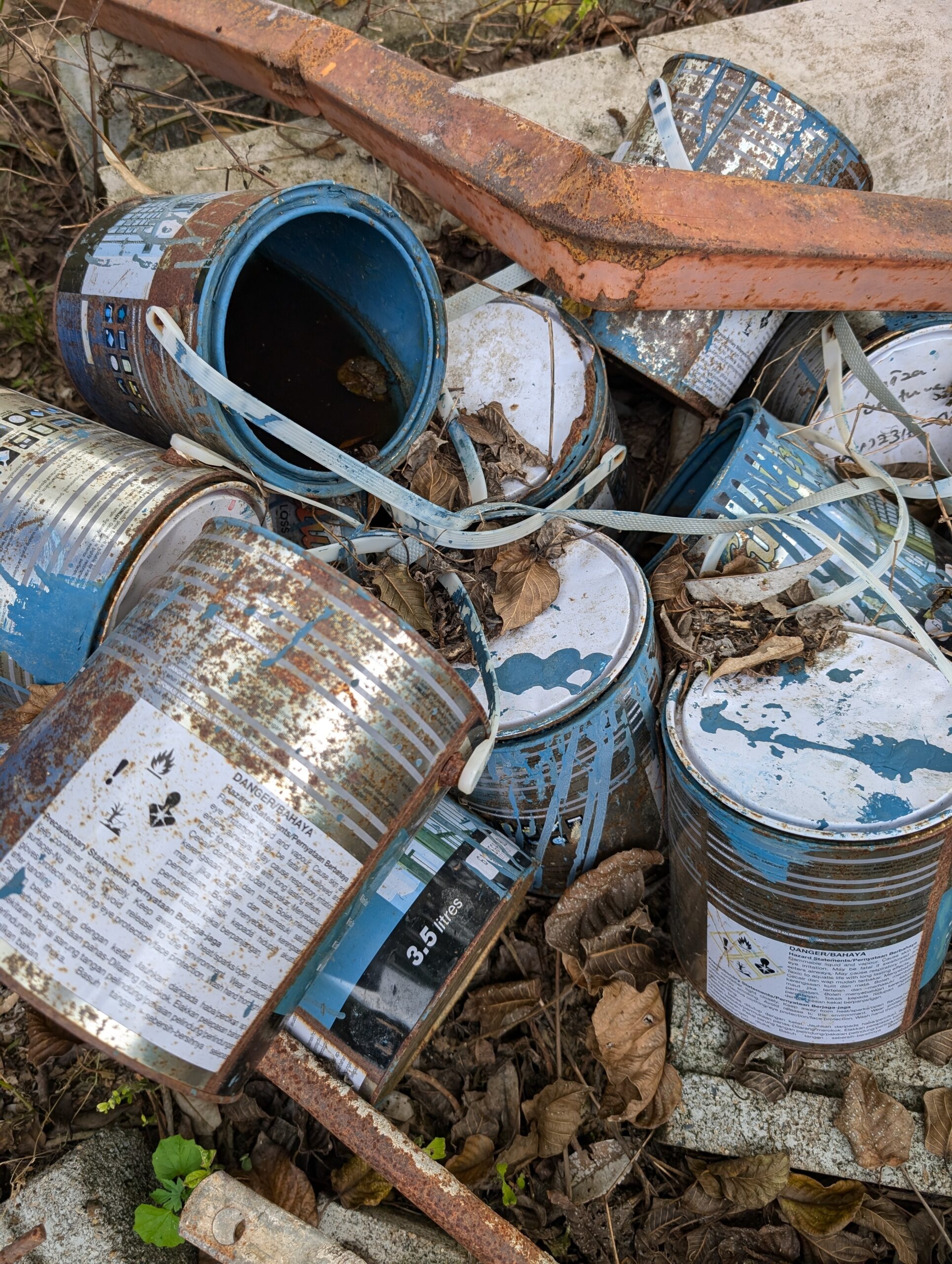 A pile of paint cans that haven't been recycled.